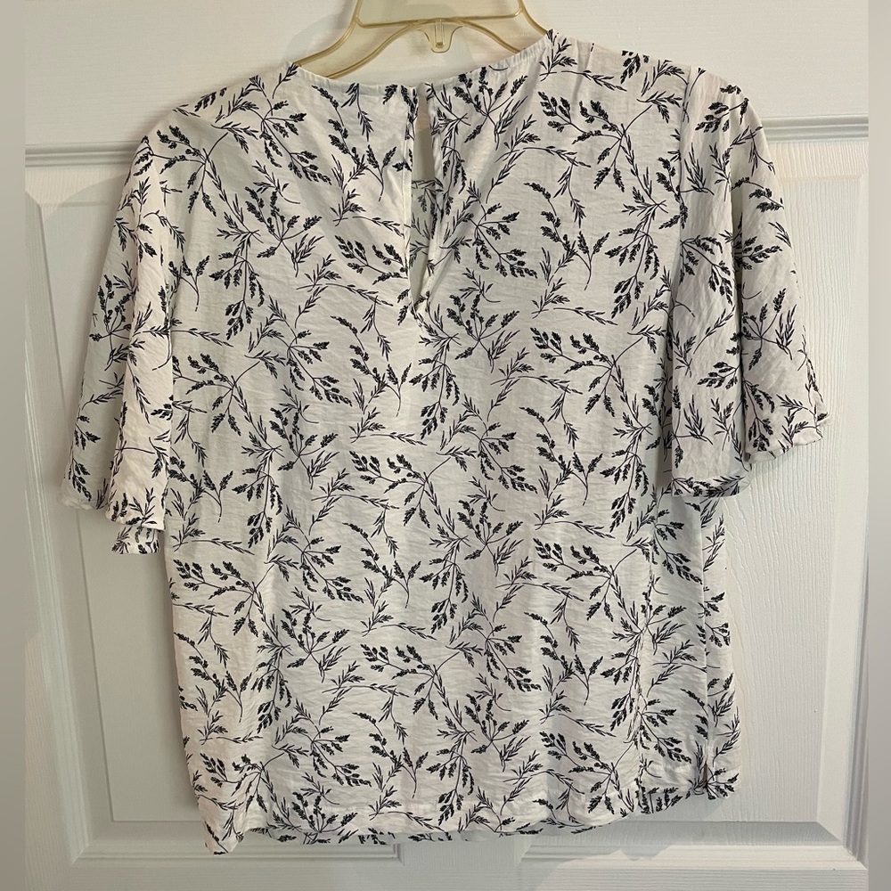 A New Day size small. White background with black print.